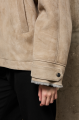 Stylish suede sheepskin coat made of natural sheepskin in beige color with a hood